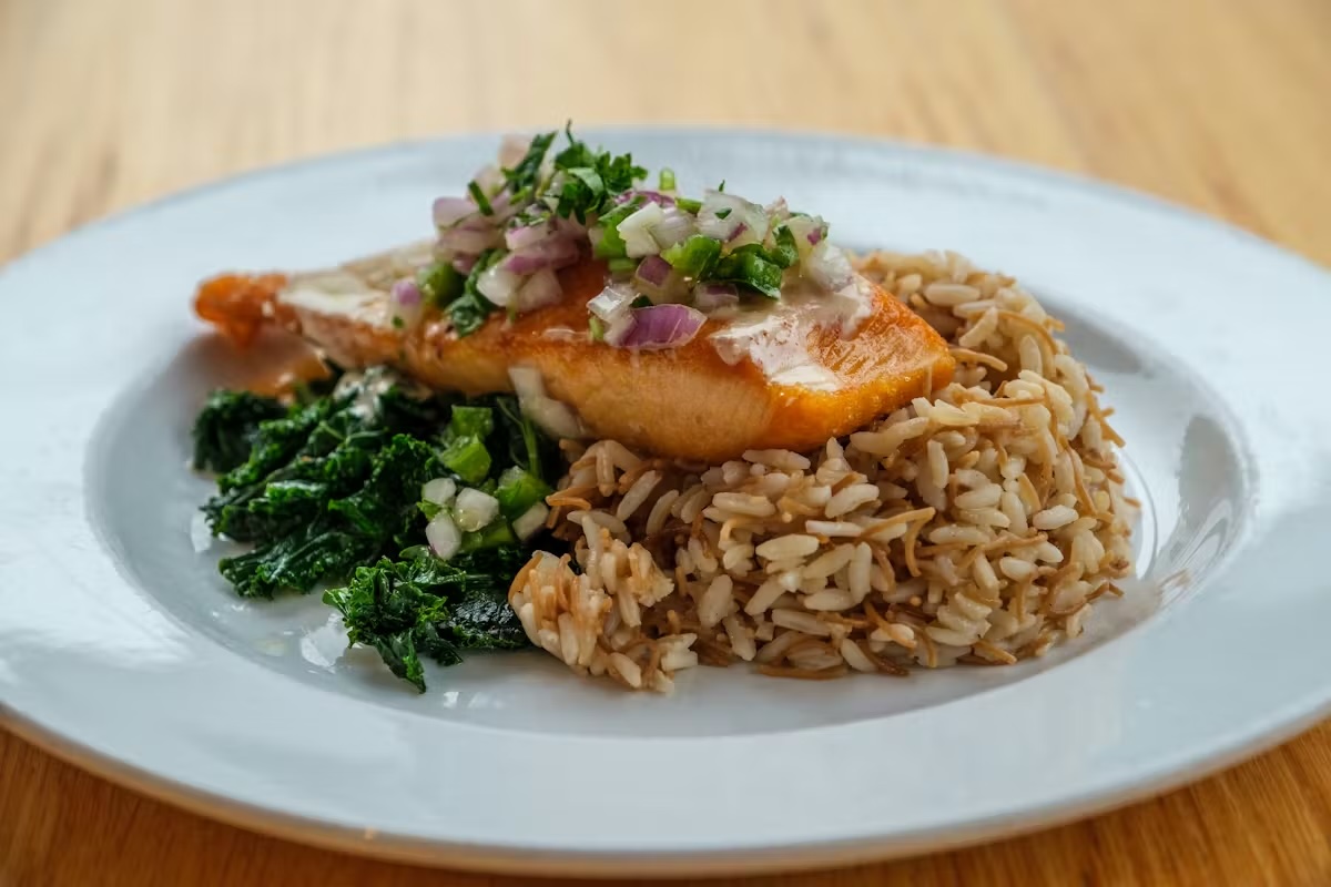 grilled salmon over rice and sautéed kale