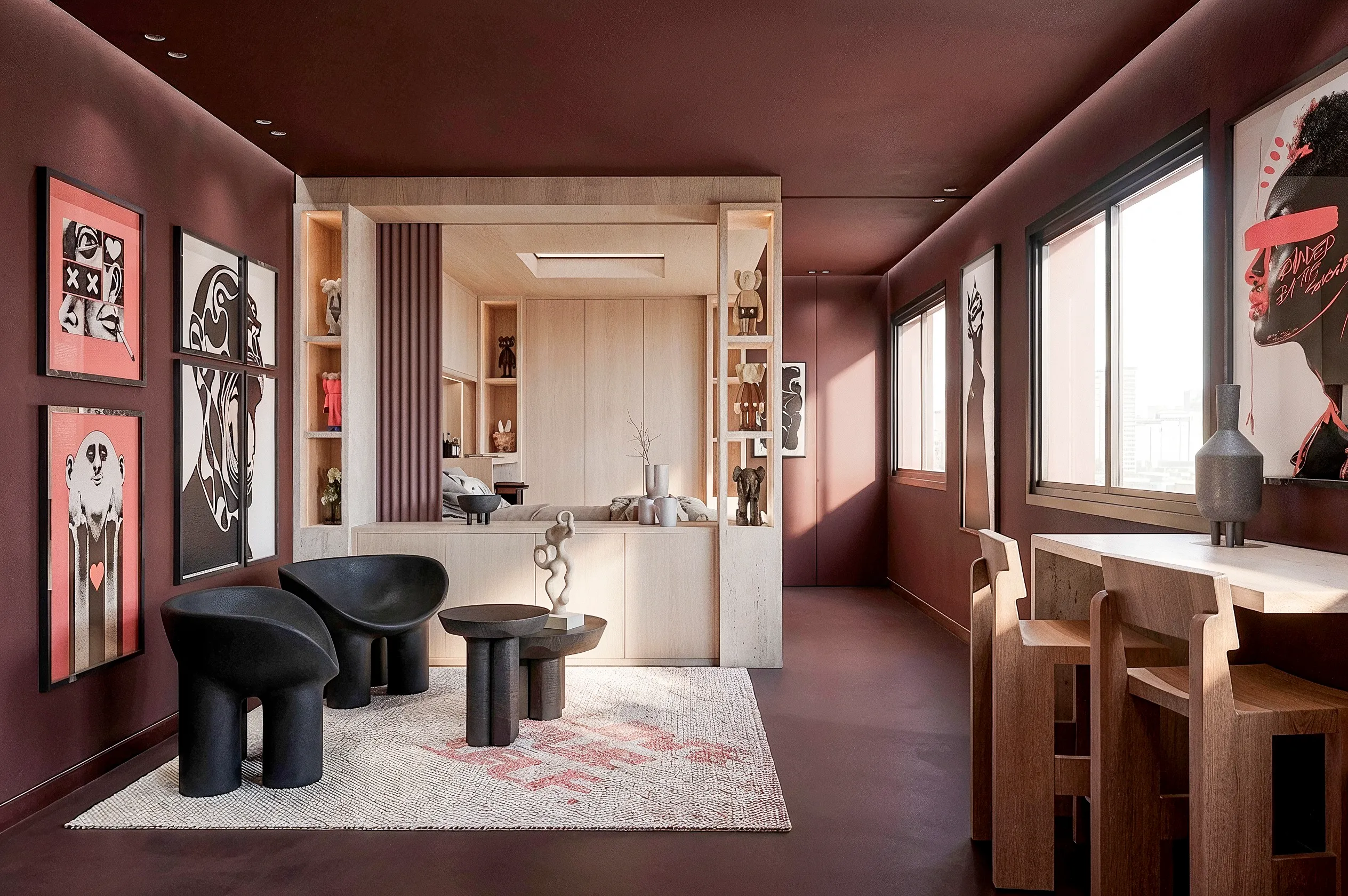 Pièce de vie bordeaux, table basse noire et œuvres graphiques aux murs — studio 40 m², Paris