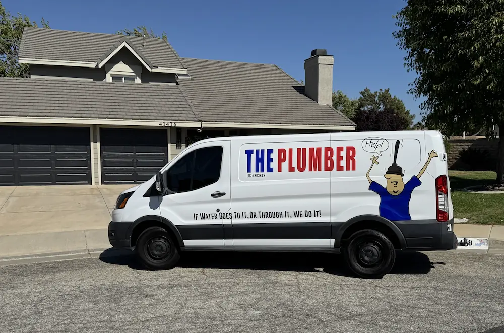 White plumber van with text The Plumber and slogan If water goes to it or through it, we do it.