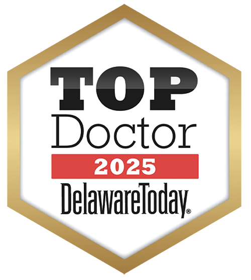 Badge with text 'TOP Doctor 2025 DelawareToday' on a white hexagon with a gold background.
