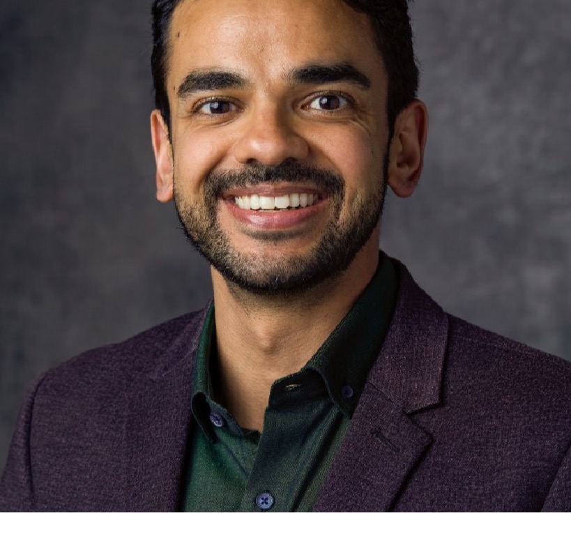 Gaurav Manchanda, founder of NextAbilities, smiling in a dark jacket and green shirt.