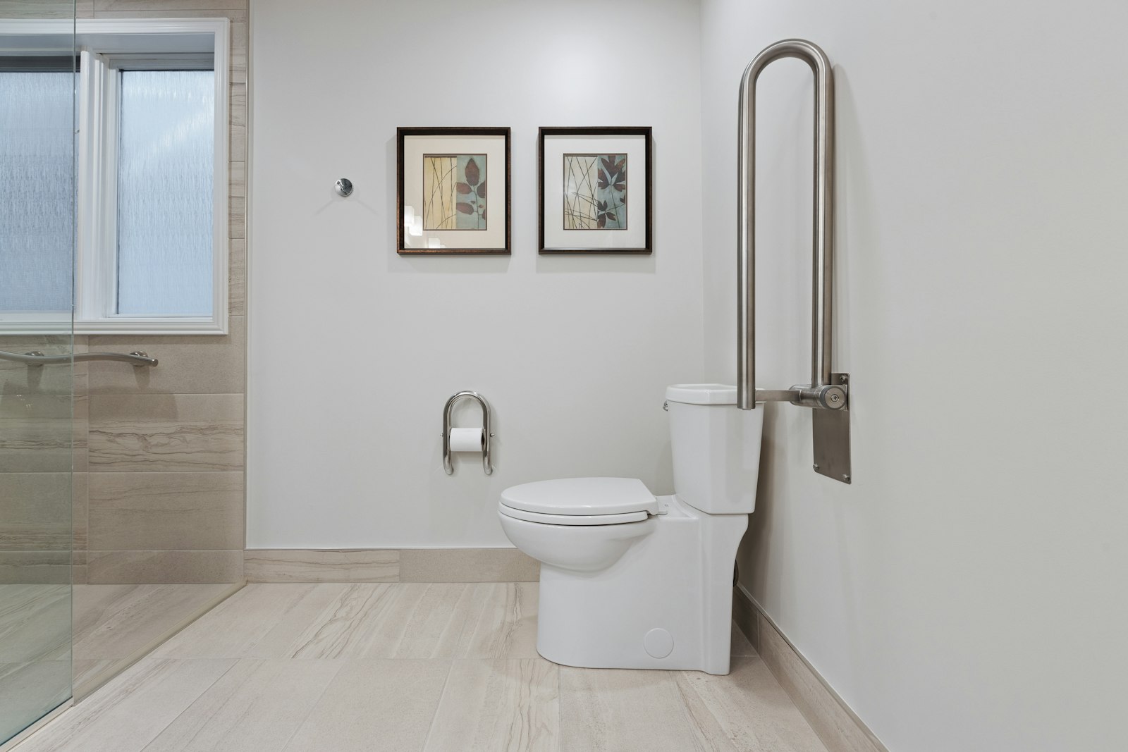 An accessible bathroom with a flip-up grab bar beside the toilet.