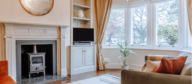 Living room with fireplace and bay window at The Harrogate Townhouse