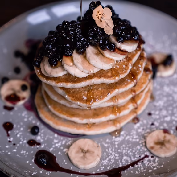 Stack of pancakes with berries at Farmhouse, Harrogate