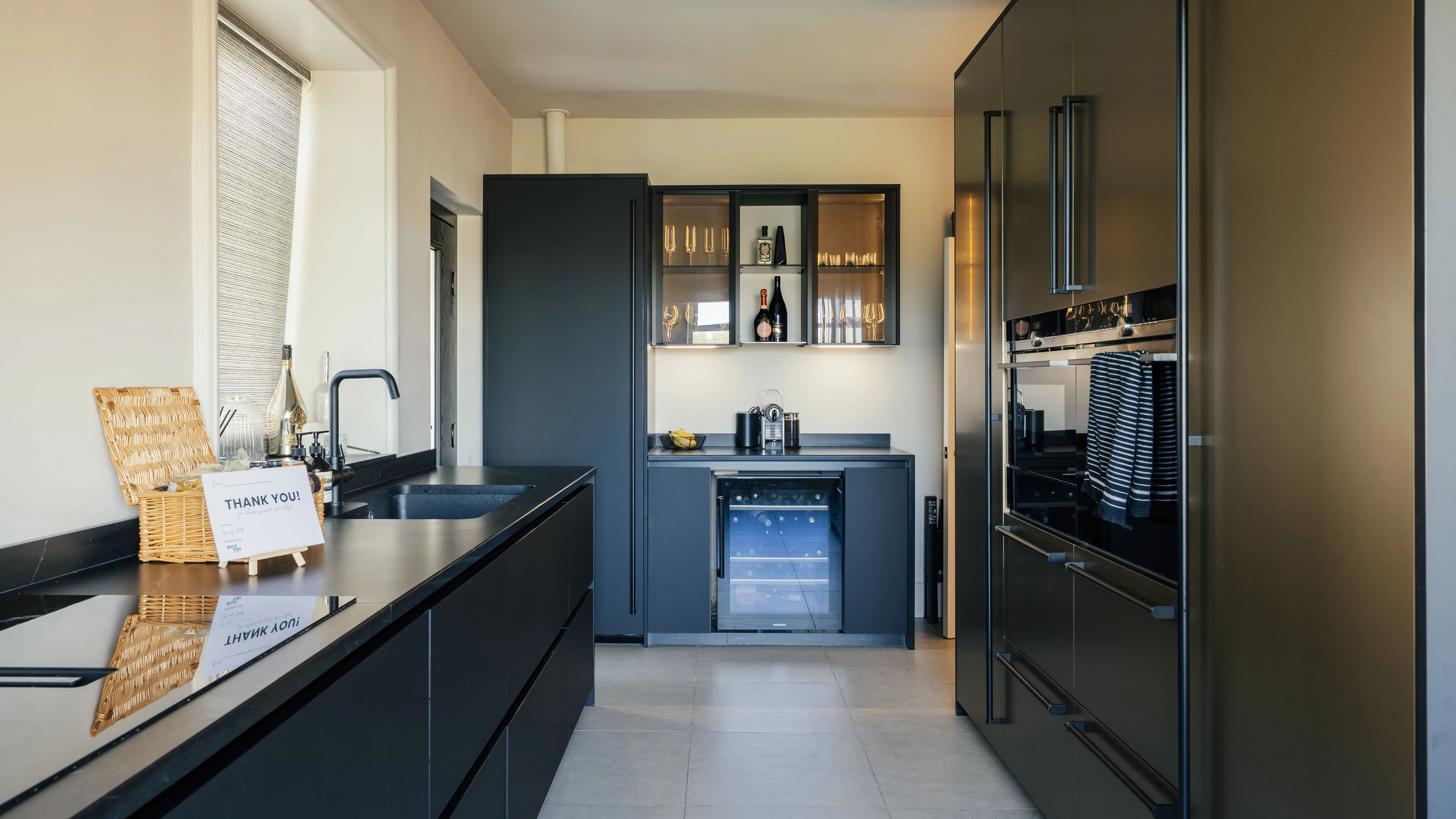 Modern dark kitchen with integrated appliances in a Harrogate apartment
