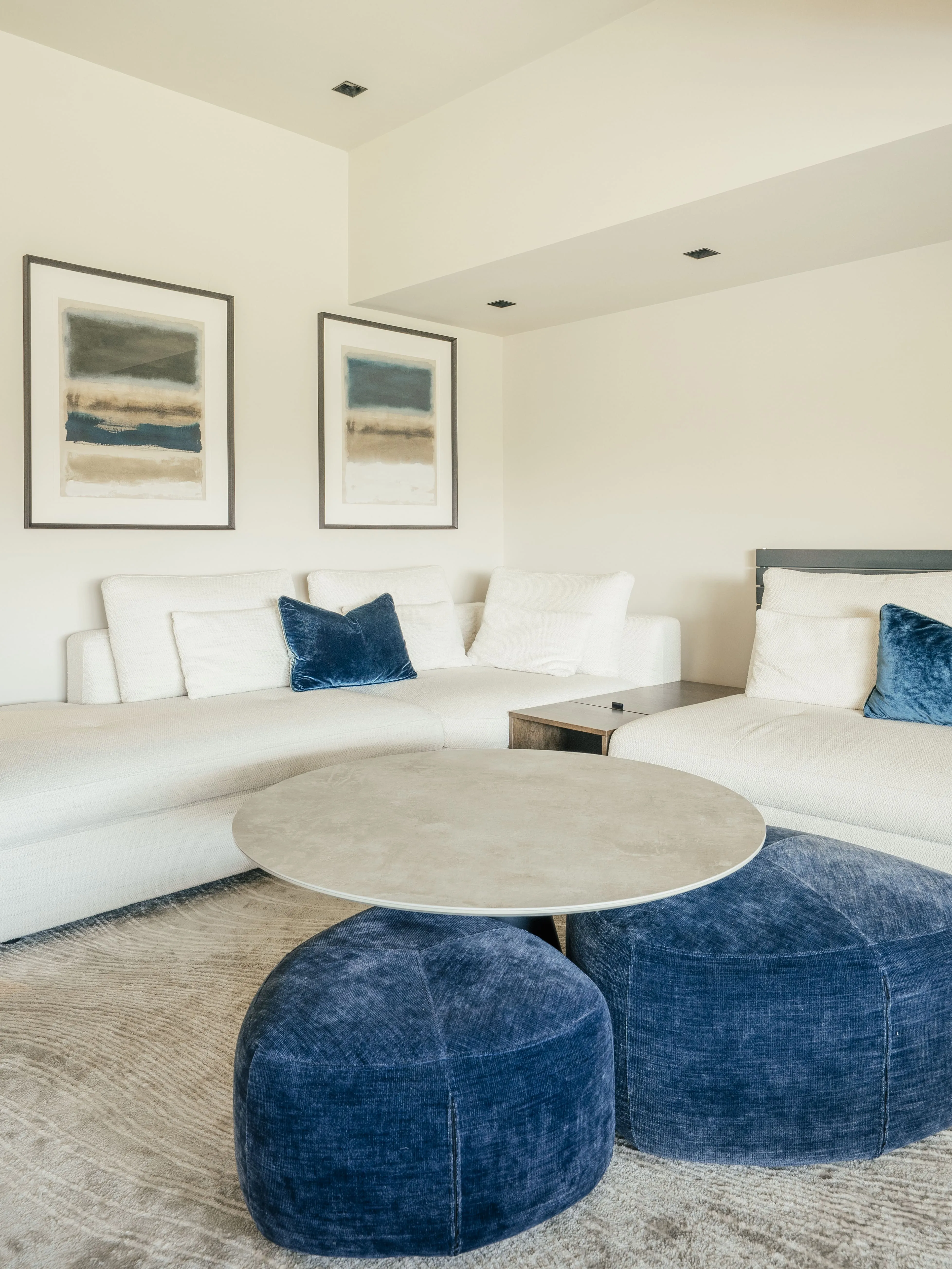 White corner sofa and blue ottomans in a bright Harrogate living room