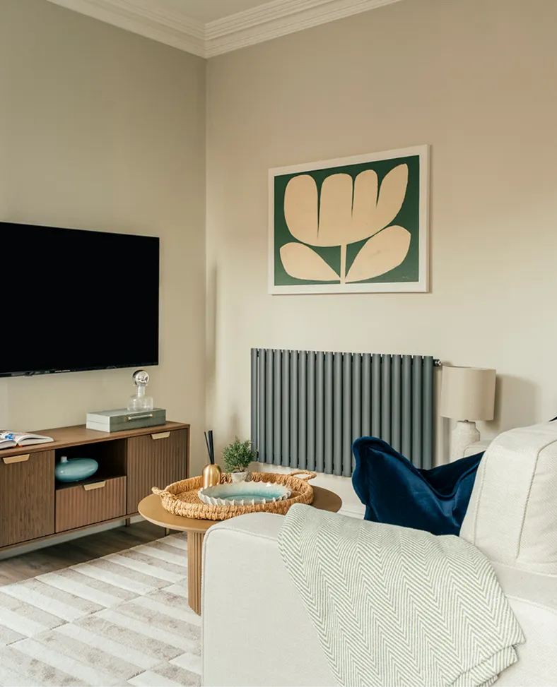 Living room with a cream sofa and navy cushions in a Harrogate apartment