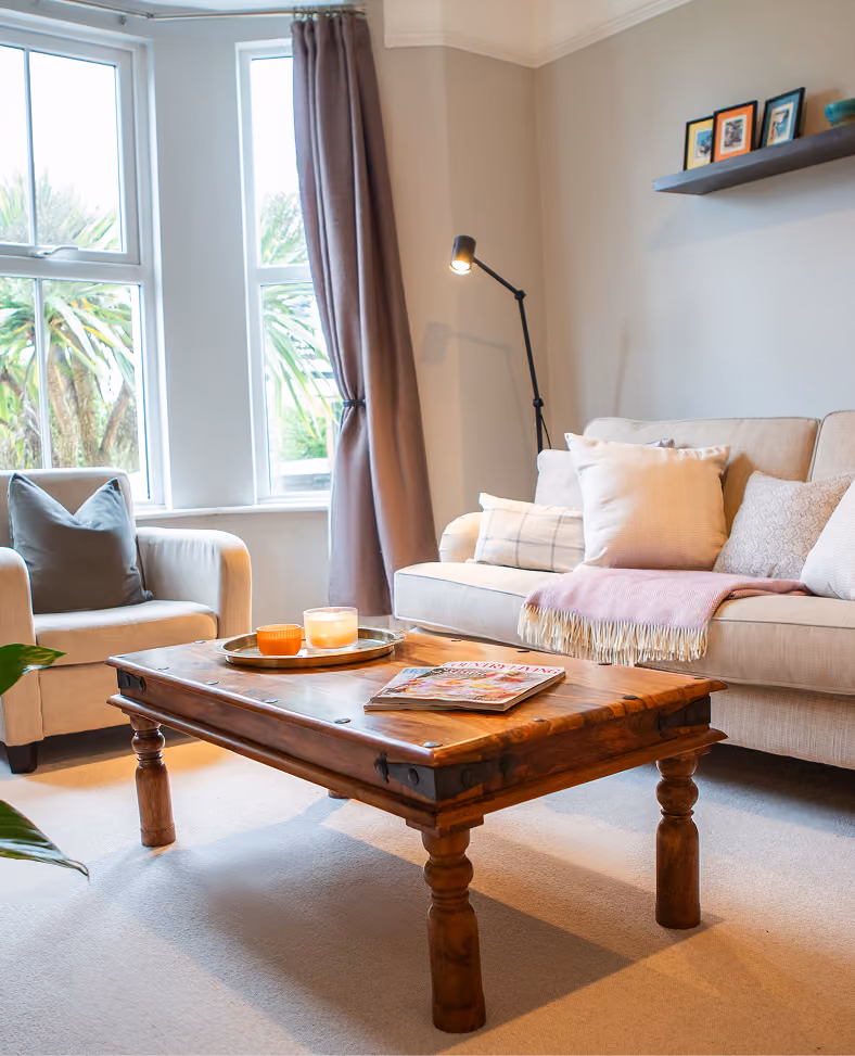 Bay-window living room with cream sofas in a Harrogate townhouse