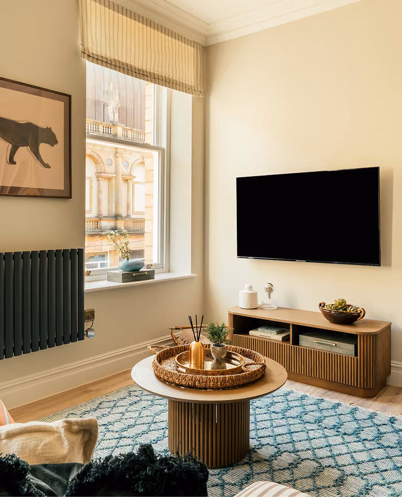 Living room with a round coffee table in a Harrogate apartment