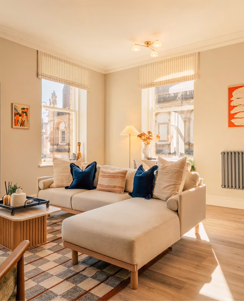 Sunny living room with a cream corner sofa in a Harrogate apartment