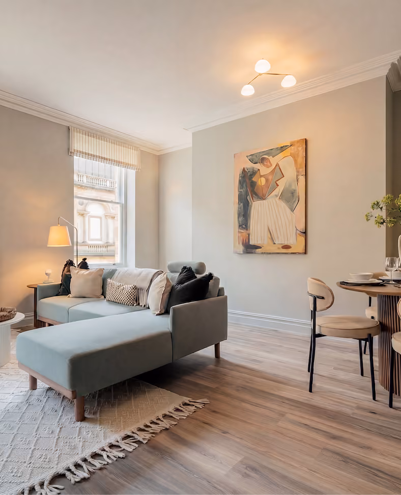 Open-plan living and dining area with a grey sofa in a Harrogate apartment