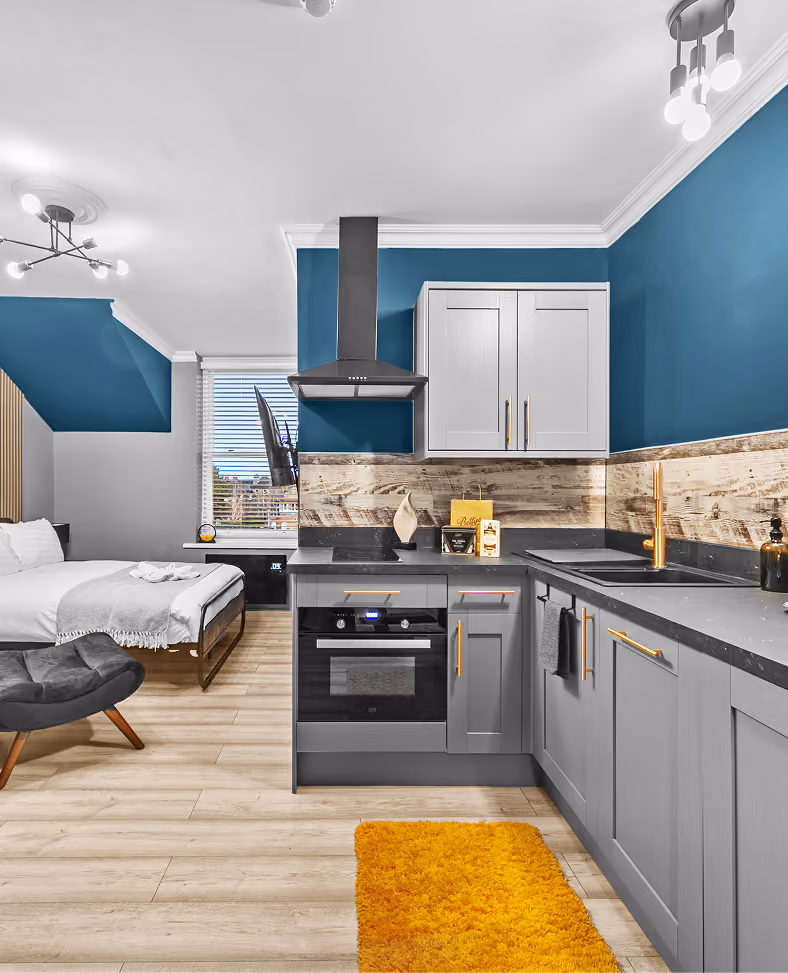 Studio apartment kitchen with blue walls in central Harrogate
