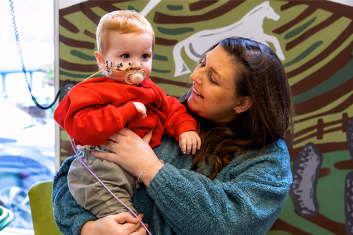 Mother holding her young child, supported by Martin House Children's Hospice
