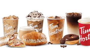 Various Tim Hortons beverages including iced coffee, latte, and hot coffee with a sandwich and a donut.
