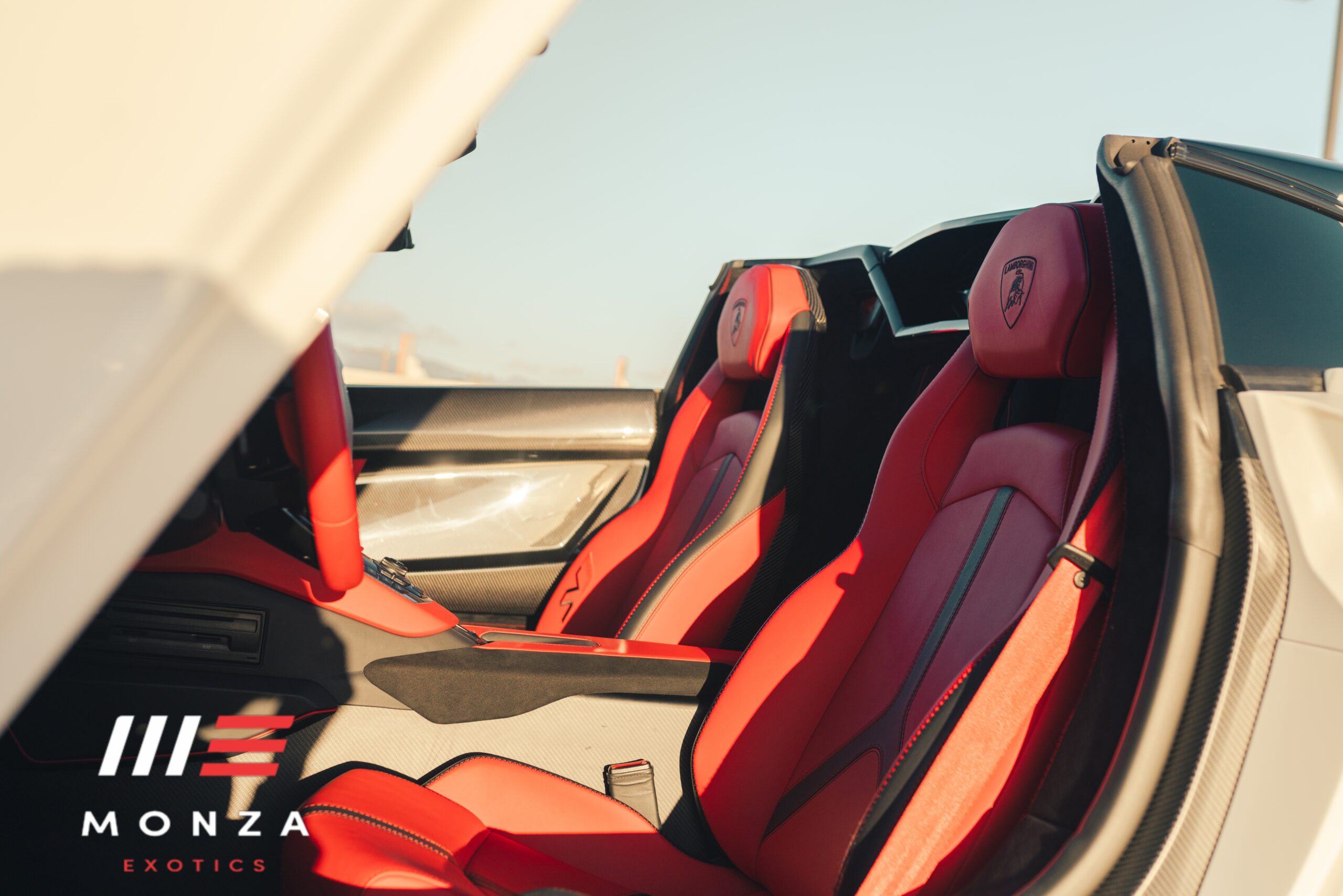 Lamborghini Aventador SVJ Roadster steering wheel and dash Red / Orange interior Pacific Coast Highway