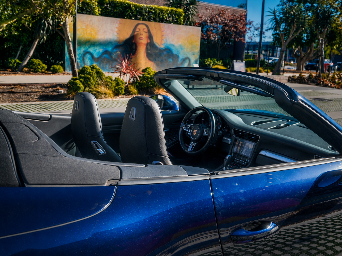 Blue Porsche 911 Carrera convertible black leather interior with top down