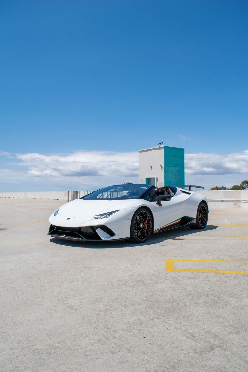 Lamborghini Huracan rental in white, a 5.2 liter V10 revving to 8,500 rpm