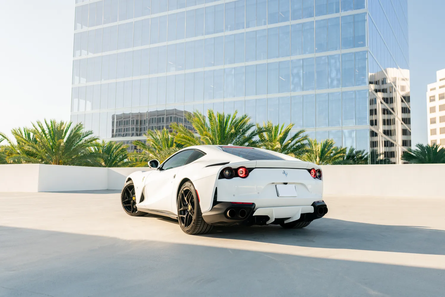 White Ferrari 812 Superfast rental, a front-engined rear-wheel drive grand tourer