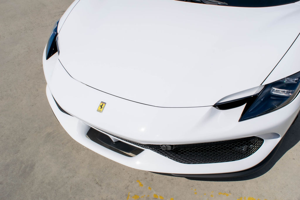 White Ferrari 296 GTB rental, a 3.0 liter twin-turbo V6 supercar