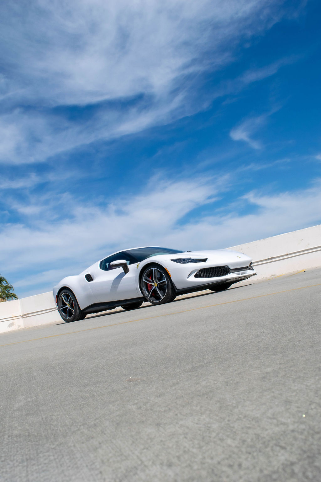 Ferrari 296 GTB rental in white, a 2 door coupe with a front trunk