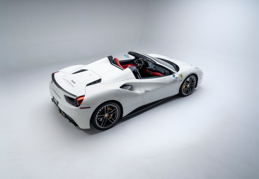 Rear view of the white Ferrari 488 Spider rental, a 205 mph supercar