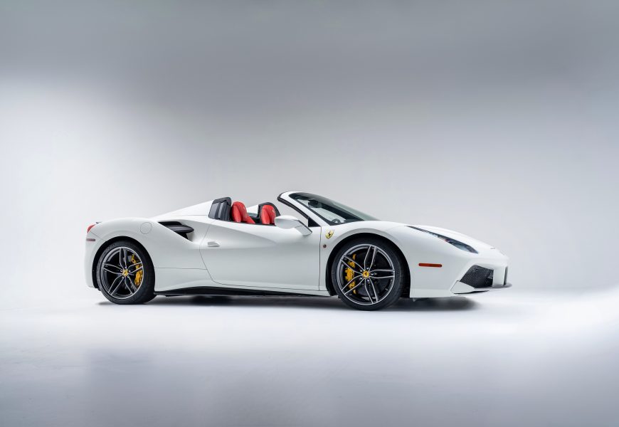 Side view of the white Ferrari 488 Spider rental, a mid-engined V8 convertible