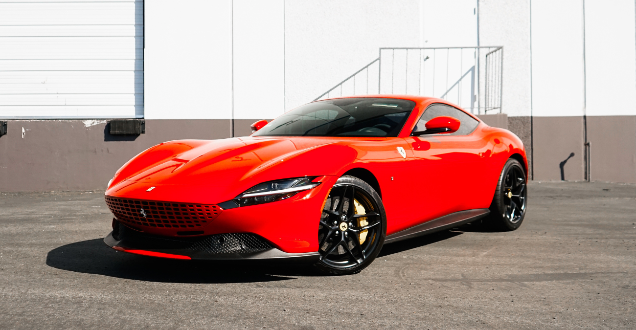 Red Ferrari Roma, front view, a 612 hp V8 coupe to rent in Southern California