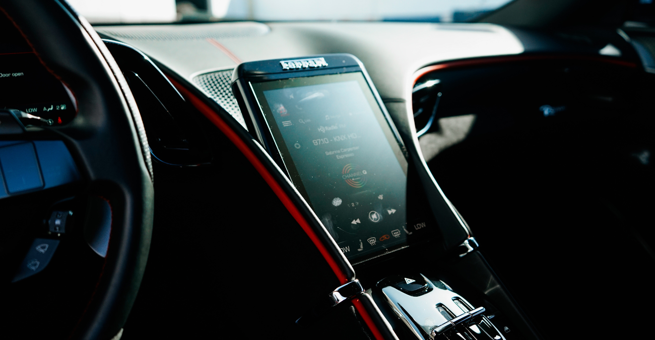 Infotainment screen in the Ferrari Roma rental, set into a dual cockpit dashboard