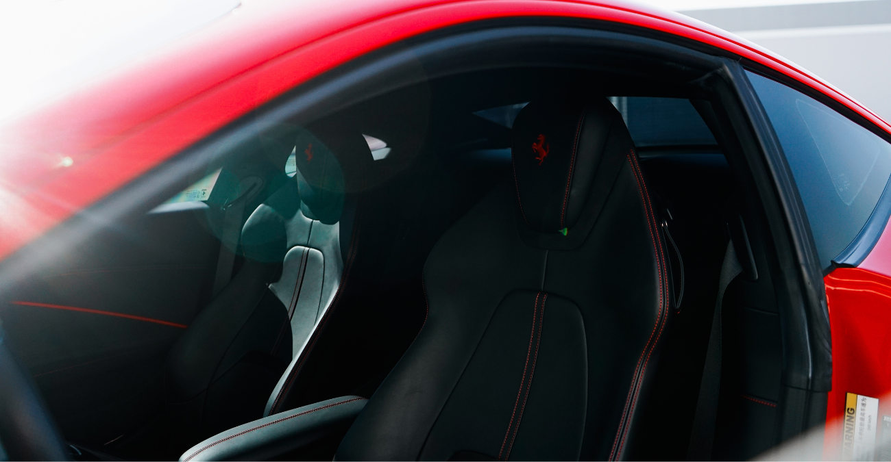 Side view of the red Ferrari Roma rental, a 2 door rear-wheel drive coupe