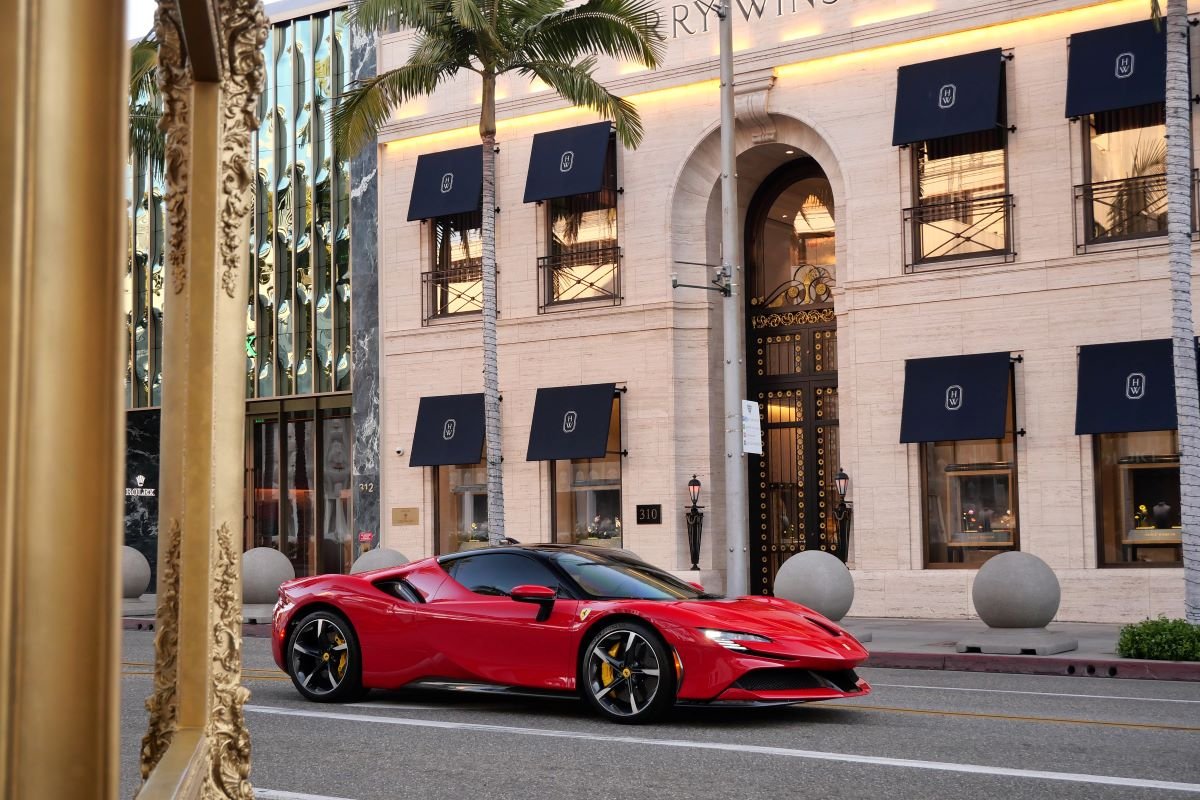 Rear view of the red Ferrari SF90 Stradale rental, a 211 mph plug-in hybrid