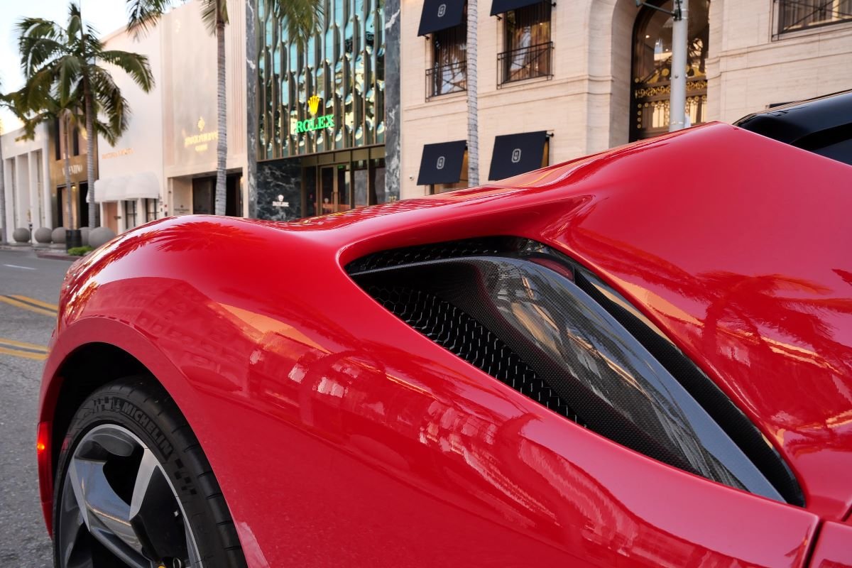 Side intake on the red Ferrari SF90 Stradale rental, a 2 seat hybrid supercar