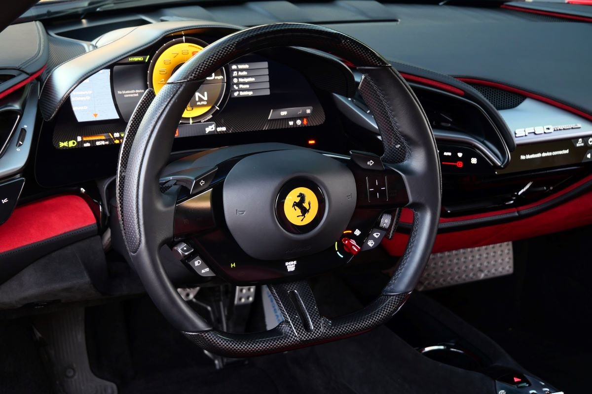 Steering wheel in the Ferrari SF90 Stradale rental, with touch controls and no rev counter