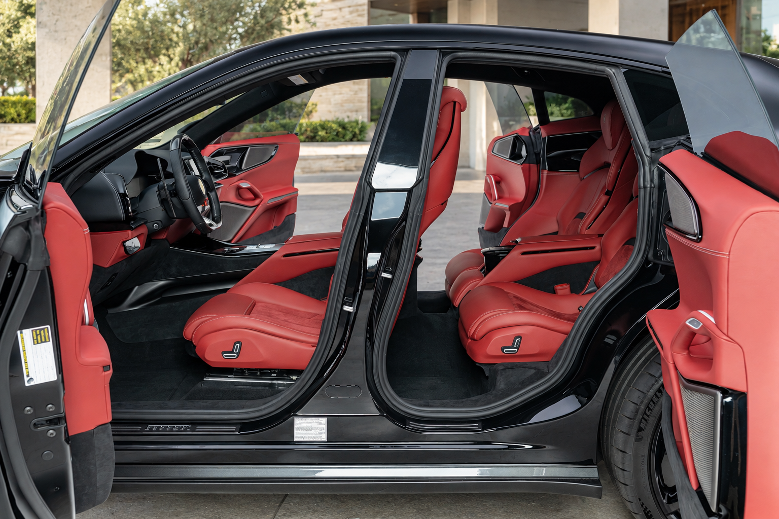 Doors open on the black Ferrari Purosangue rental, the rear pair hinged at the back