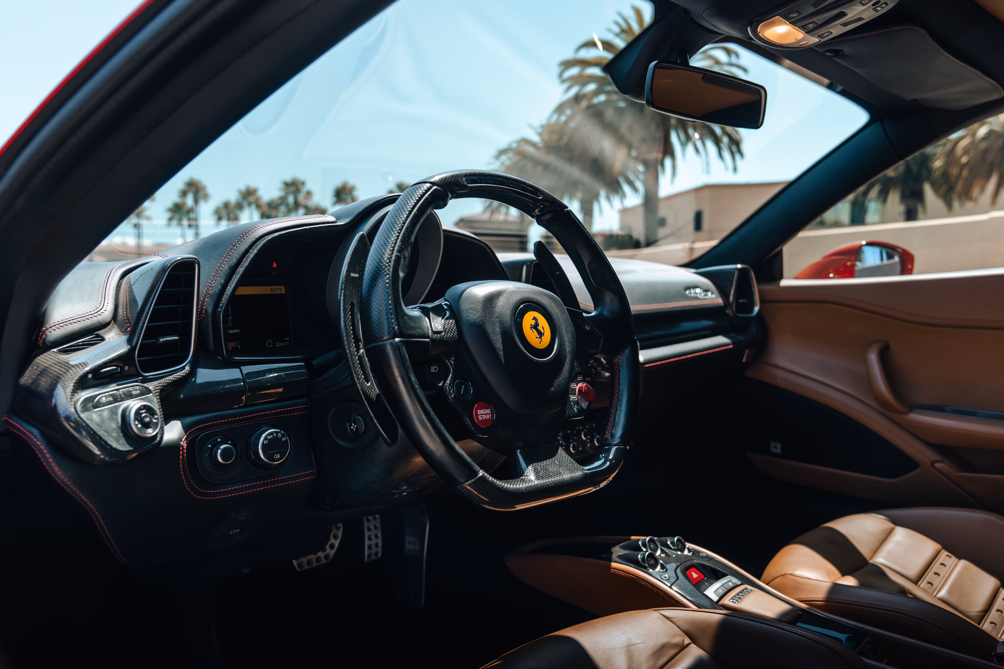 Dashboard of the Ferrari 458 Italia rental, built around a central analog rev counter