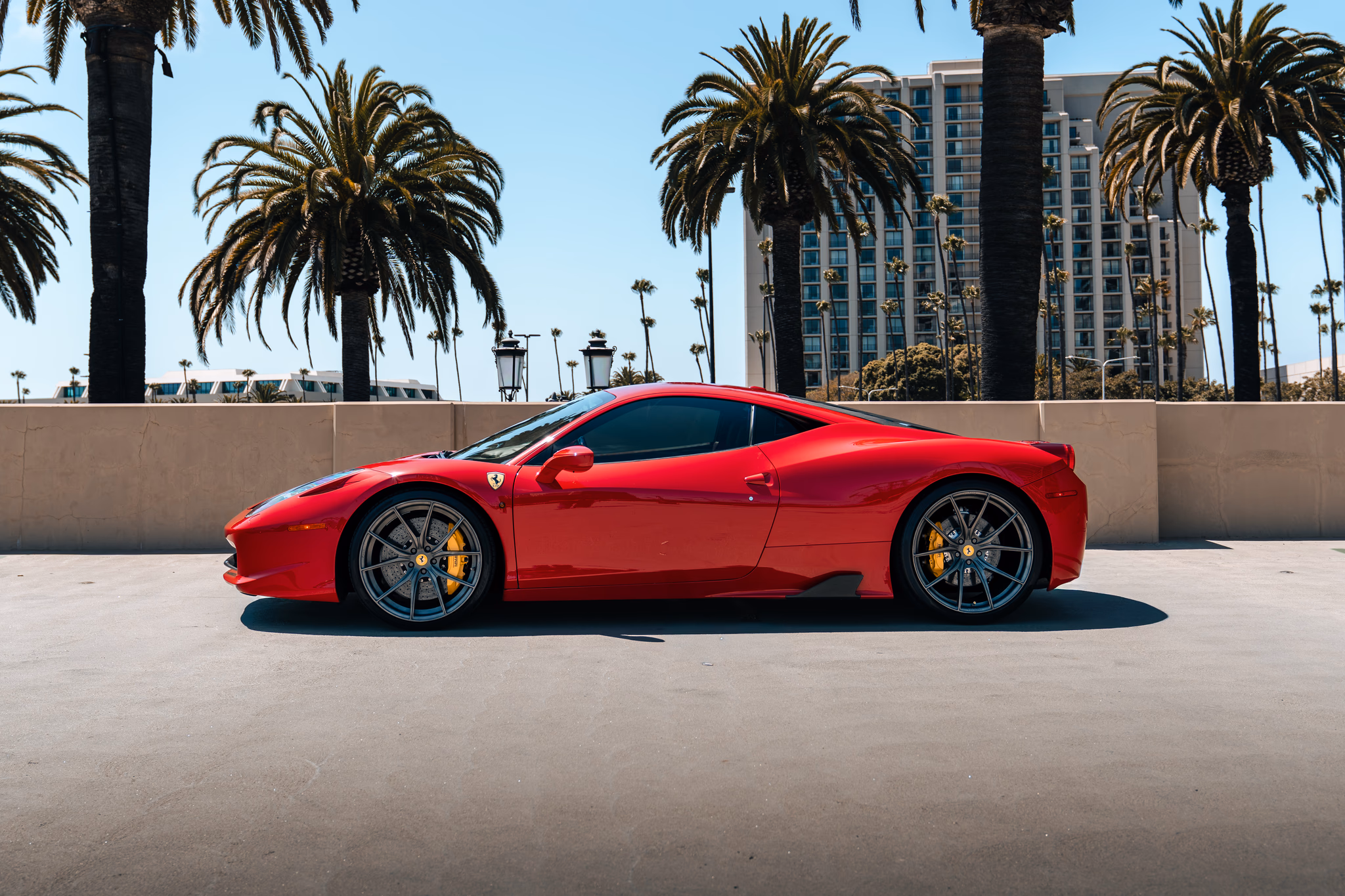 Side view of the red Ferrari 458 Italia rental, a mid-engined V8 coupe