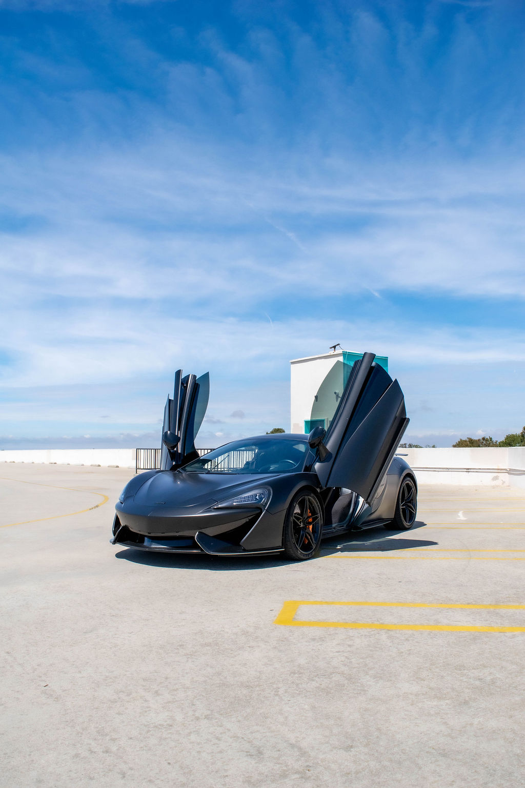 Black McLaren 570S rental, a 3.8 liter V8 with hydraulic steering