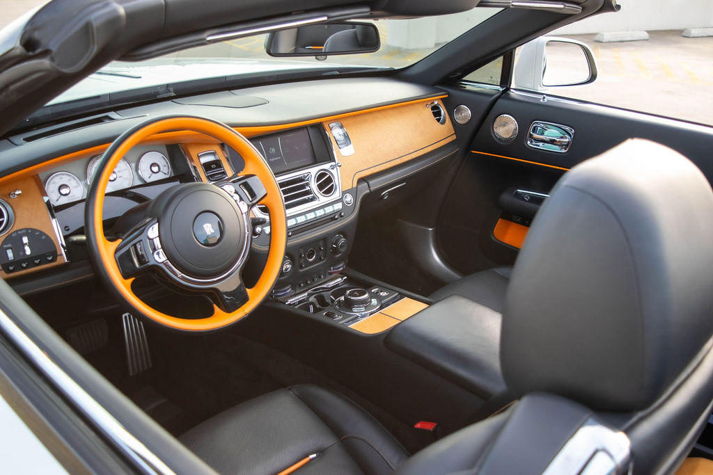 White Rolls Royce Dawn rental, a 4 seat rear-wheel drive convertible