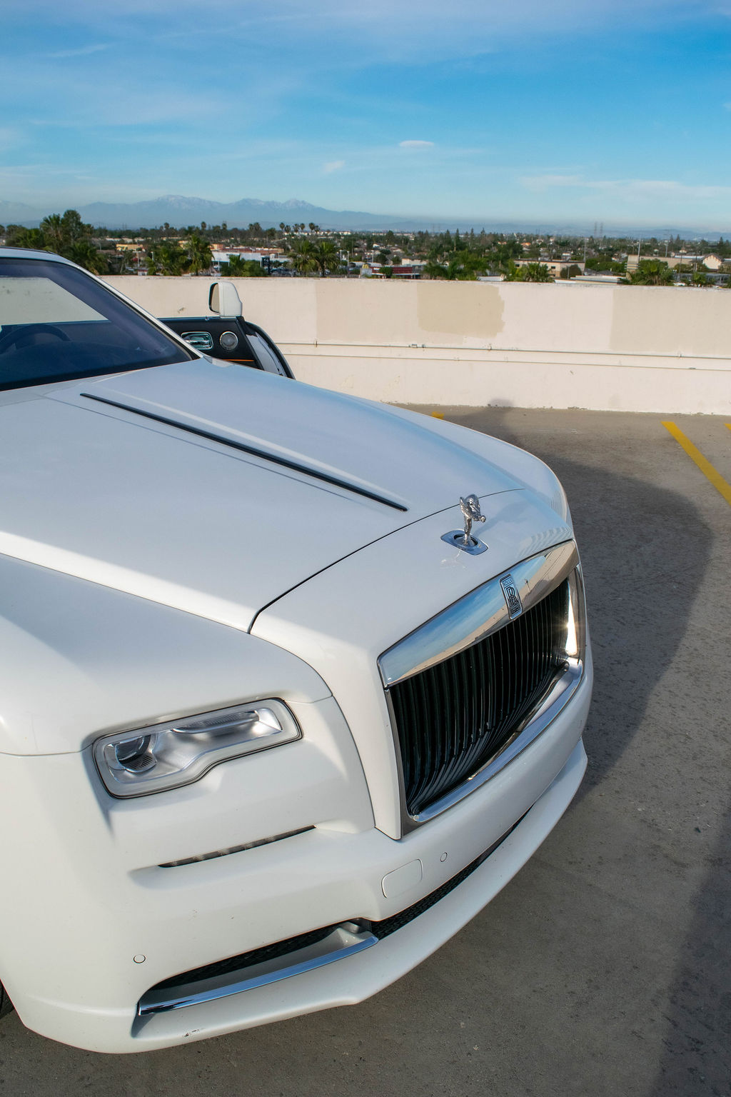 White Rolls Royce Dawn rental, with a fabric roof that lowers in around 20 seconds