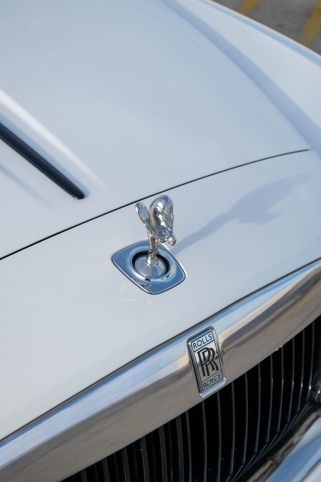White Rolls Royce Dawn rental, a V12 convertible with a 155 mph top speed