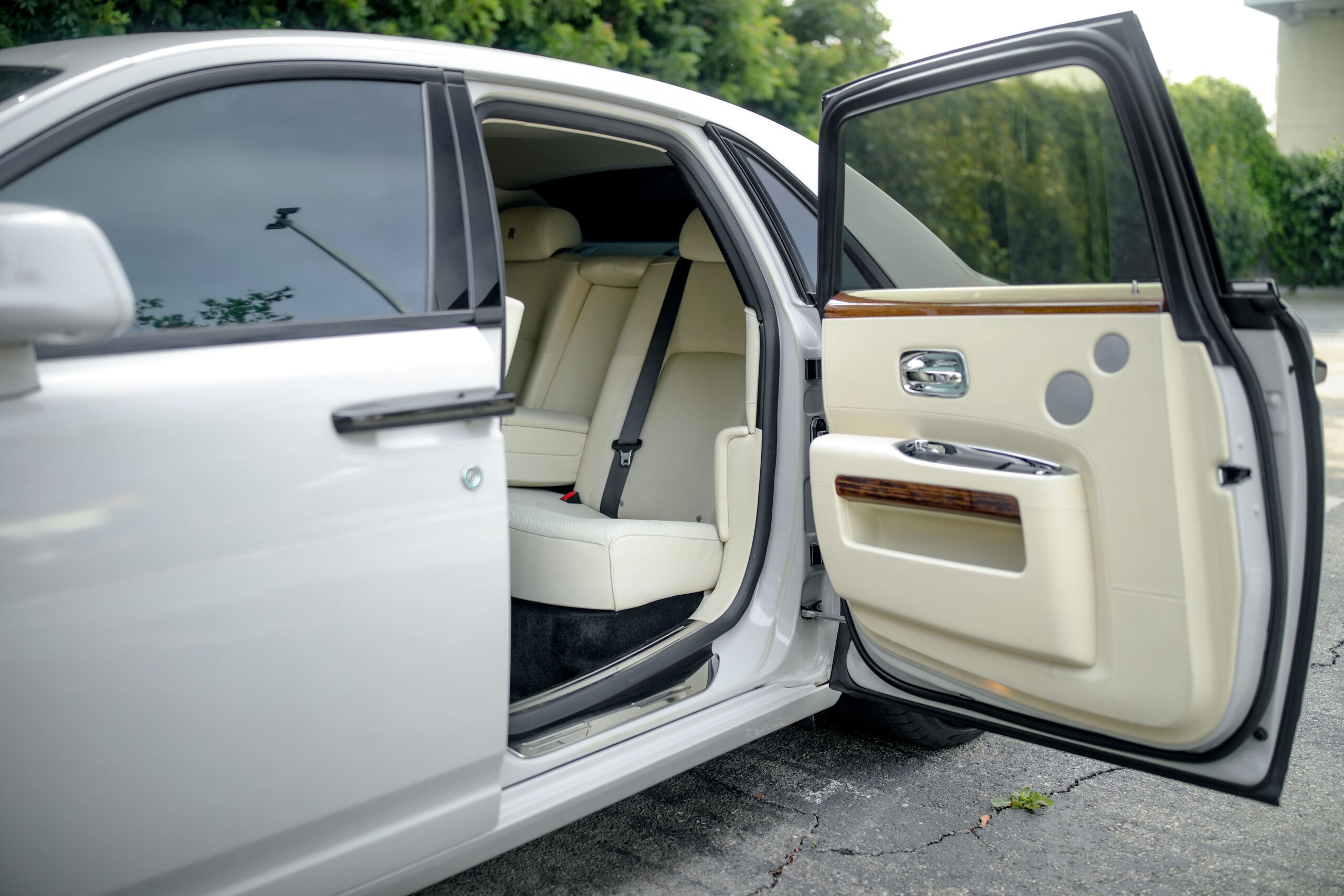 Rear doors open on the white Rolls Royce Ghost rental, a 4 door V12 sedan