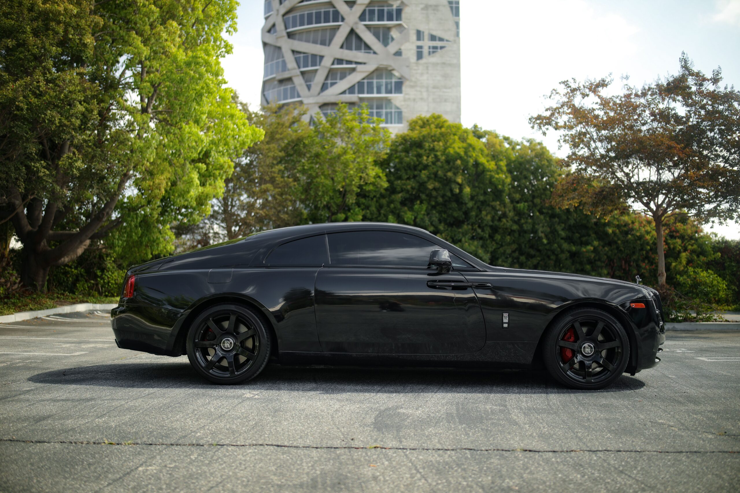 Side view of the black Rolls Royce Wraith rental, a rear-wheel drive V12 coupe
