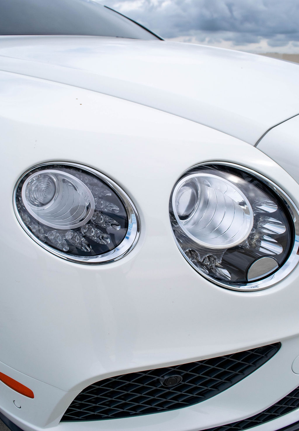 White Bentley Continental GTC rental, a Bentley convertible with a folding fabric roof