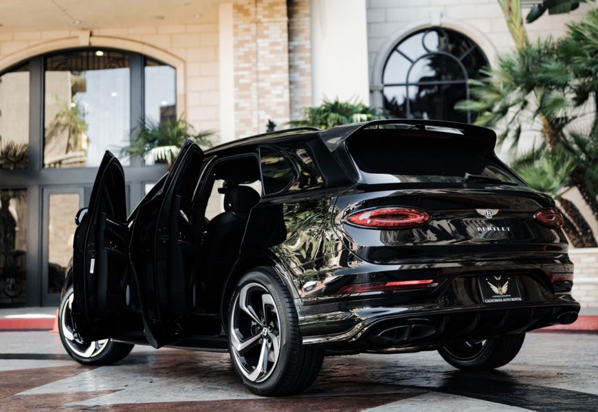 Rear doors open on the black Bentley Bentayga rental, a 5 seat luxury SUV