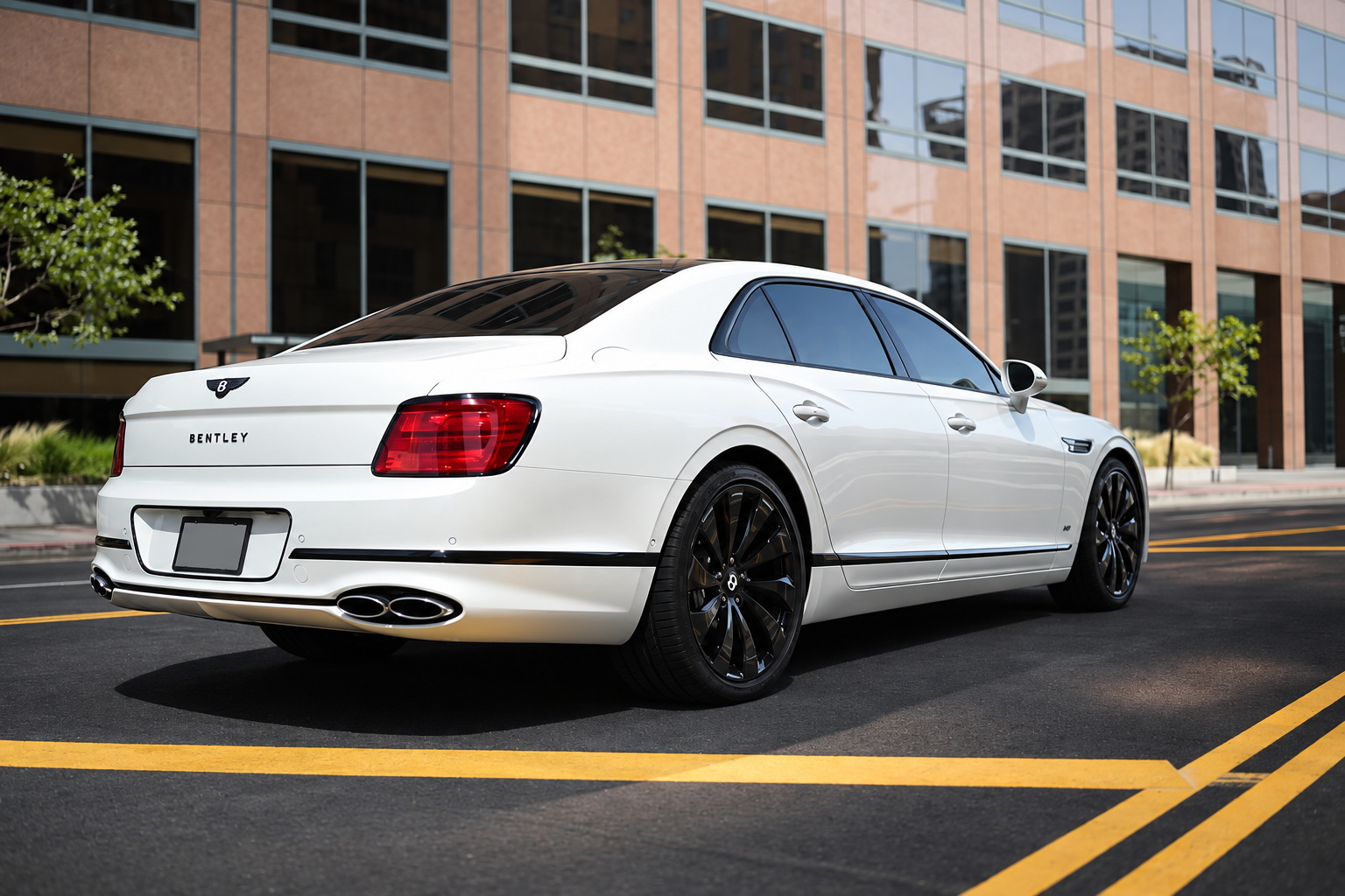 Rear view of the white Bentley Flying Spur rental, an all-wheel drive luxury sedan