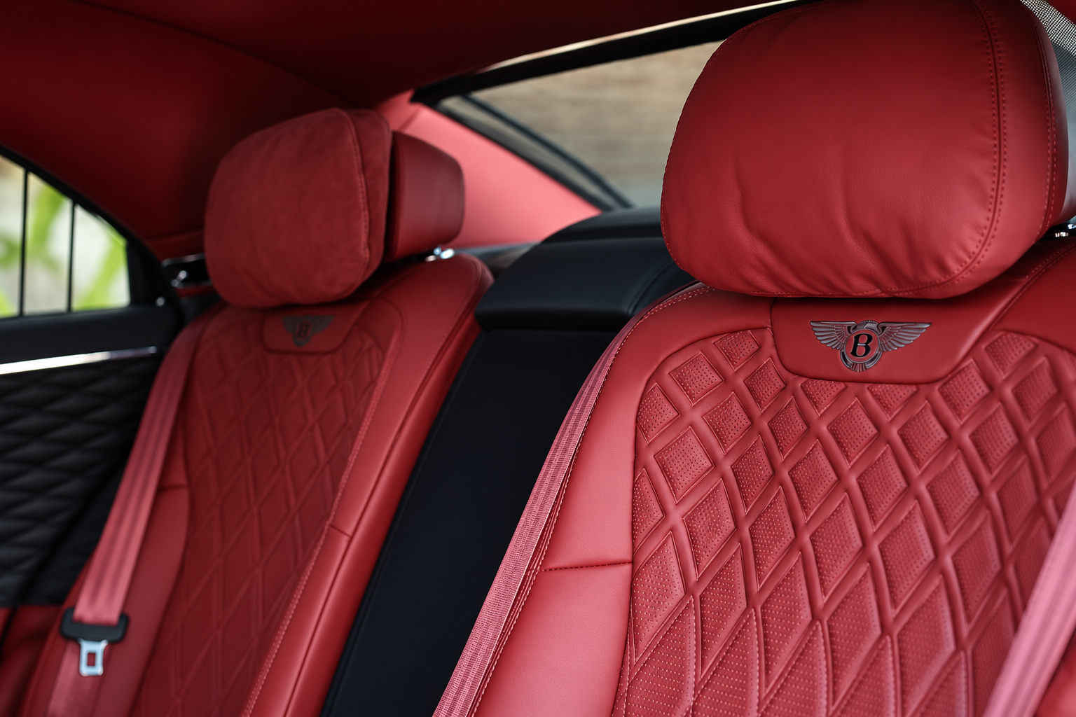 Rear cabin of the Bentley Flying Spur rental, trimmed with red seats