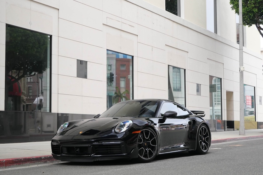 Front view of the black Porsche 911 Turbo rental, a 640 hp all-wheel drive coupe