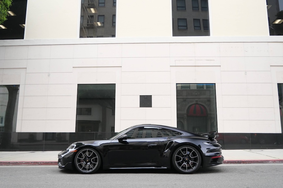Side view of the black Porsche 911 Turbo S rental, with center-lock wheels