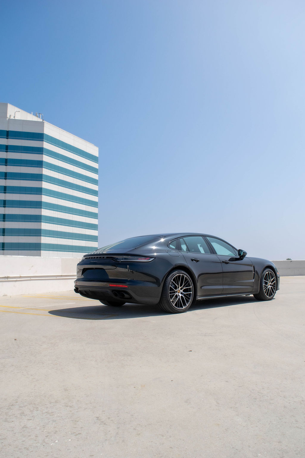 Porsche Panamera rental in black, reaching 60 mph in 5.4 seconds