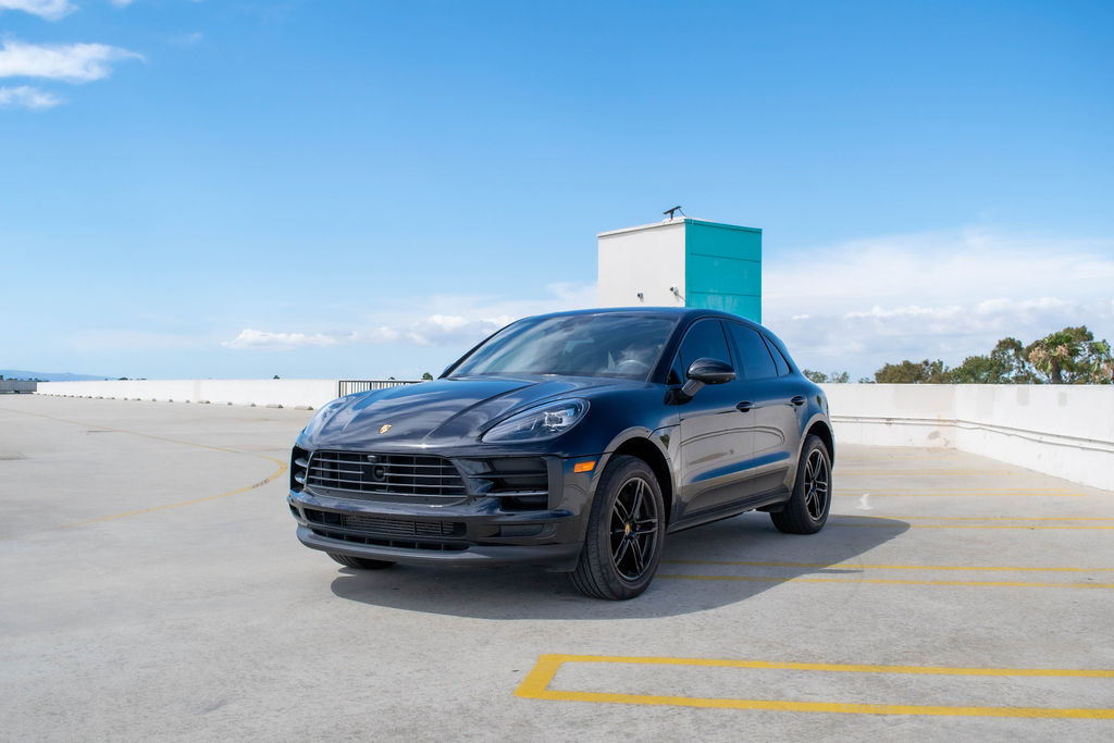 Black Porsche Macan rental, a 5 seat SUV with folding rear seats