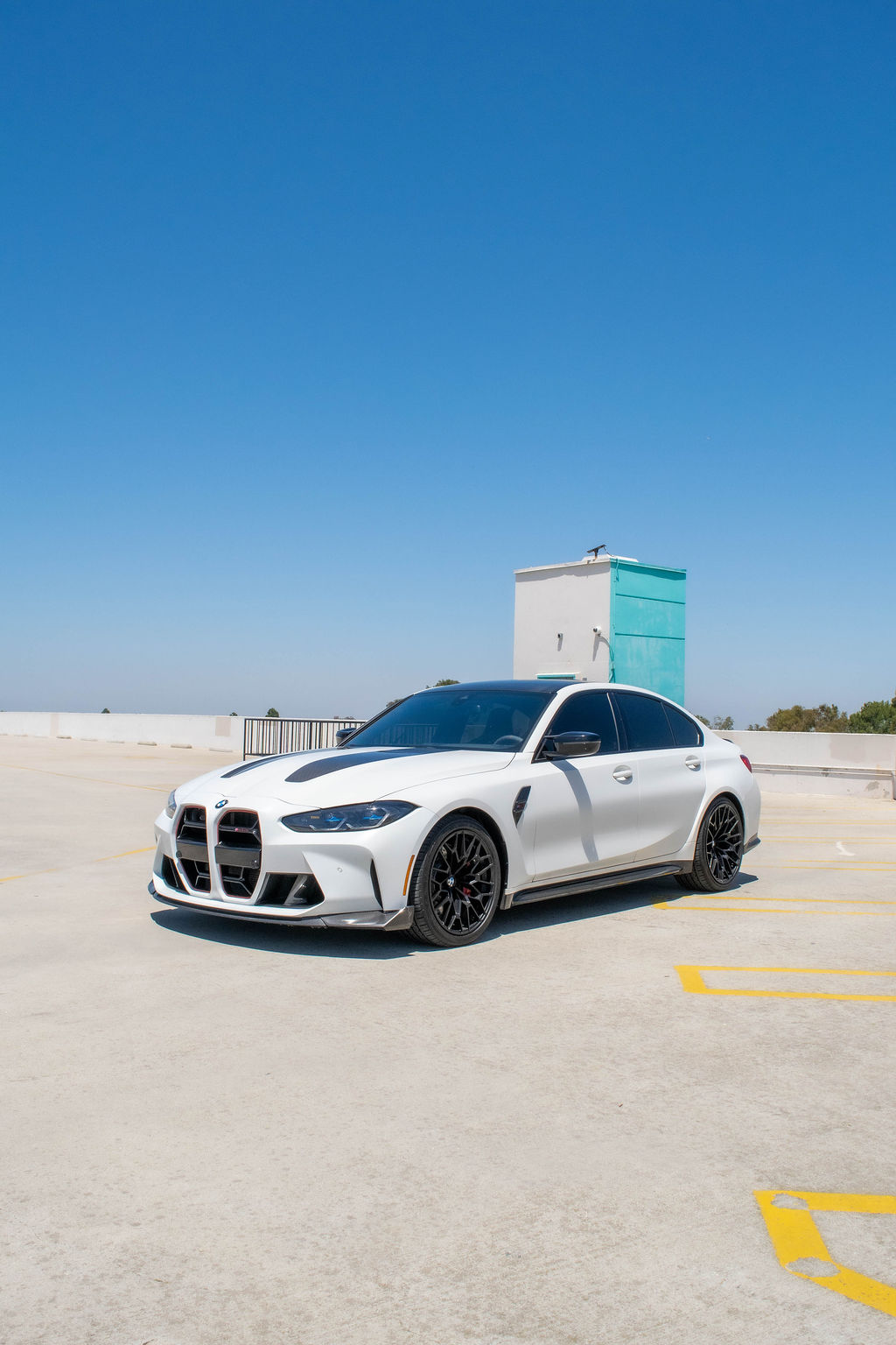 BMW M3 rental, a 543 hp twin-turbo inline-six sports sedan in white